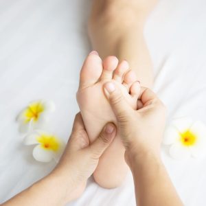 woman-receiving-foot-massage-service-from-masseuse-close-up-hand-foot-relax-foot-massage-therapy-service-concept-min